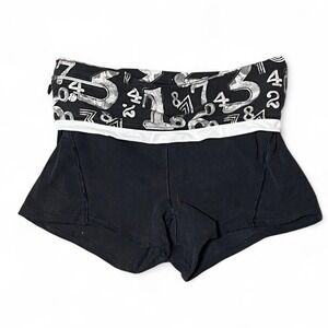 black and white foldover shorts w/ numerical pattern and zipper pocket